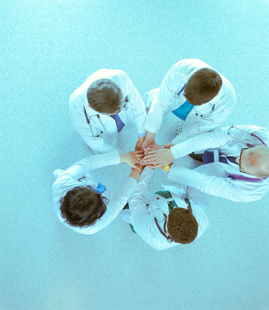 Doctors and nurses in a medical team stacking hands, top viewの写真素材