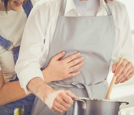 Couple cooking together in the kitchen at home