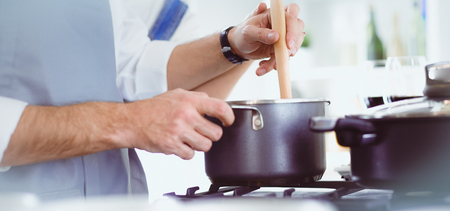 Couple cooking together in the kitchen at homeの写真素材