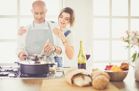 Couple cooking together in the kitchen at homeの写真素材