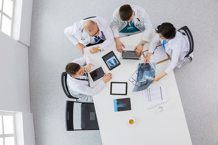 Medical team sitting and discussing at table, top viewの写真素材