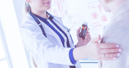 Doctor and patient discussing something while sitting at the table . Medicine and health care conceptの写真素材