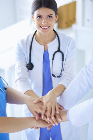 Group of doctors putting their hands together
