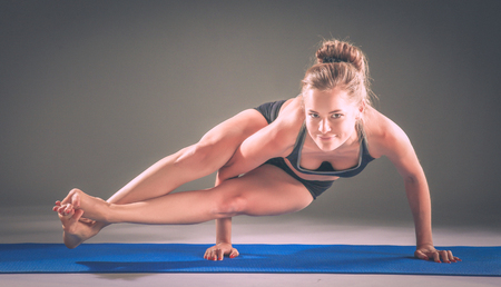 Portrait of sport girl doing yoga stretching exerciseの写真素材