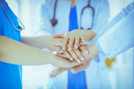 Group of doctors putting their hands together. Close-upの写真素材