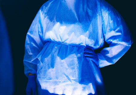 Doctors team in surgery in a dark background.の写真素材