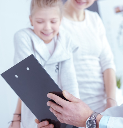 Little girl with her mother at a doctor on consultationの写真素材