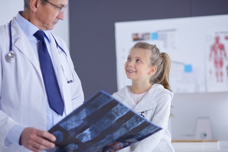 Little girl with her mother at a doctor on consultationの写真素材