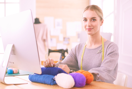 Fashion designer using tablet computer in the studioの写真素材
