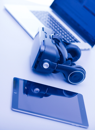 Virtual reality goggles on desk with laptop. business. 3d technologyの写真素材