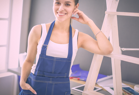 Worker woman with drill standing in new home.の写真素材