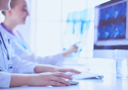 Two young female doctors working on computer at hospital.の写真素材