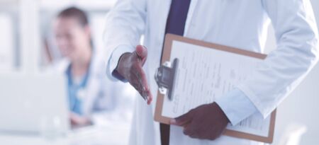 Male medicine doctor offering hand to shake in office closeup. Doctorsの写真素材