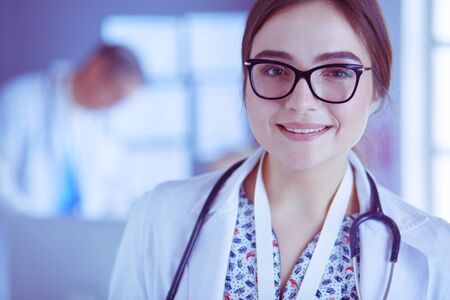 Female doctor using tablet computer in hospital lobbyの写真素材