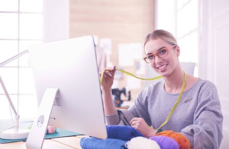 Fashion designer using tablet computer in the studioの写真素材