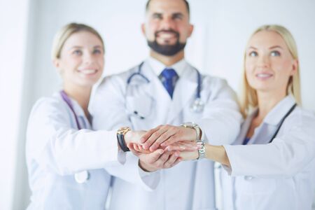 Doctors and nurses in a medical team stacking handsの写真素材