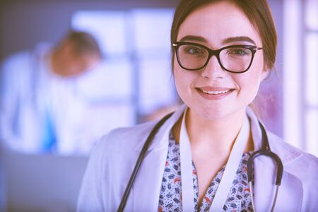 Female doctor using tablet computer in hospital lobbyの写真素材