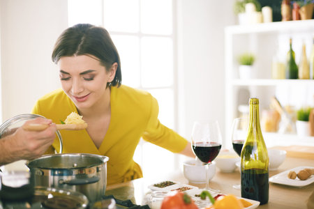 Couple cooking together in the kitchen at homeの写真素材