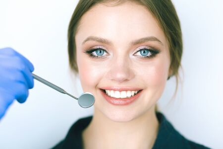 Dentist and patient sitting in dentist officeの写真素材