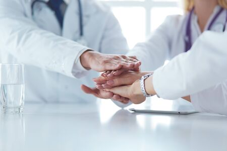 Doctor shaking hands with a male patient in the office.の写真素材