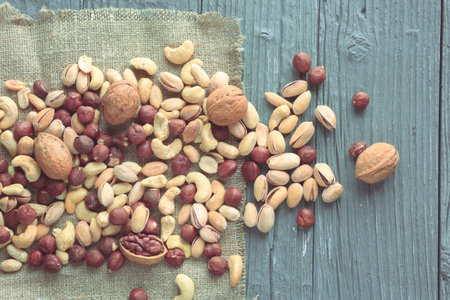 Nuts decorated in a plate on a wooden desk