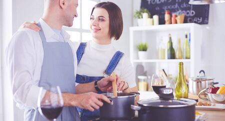 Couple cooking together in the kitchen at homeの写真素材