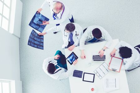 Medical team sitting and discussing at table, top viewの写真素材