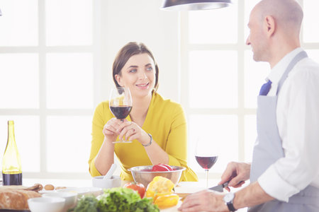 Couple cooking together in the kitchen at home