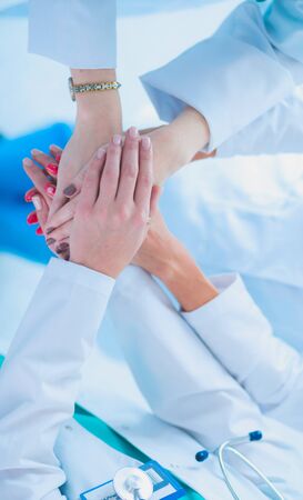 Doctors and nurses in a medical team stacking handsの写真素材