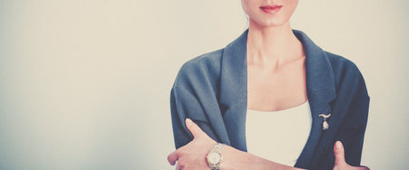 A young woman standing, isolated on gray background