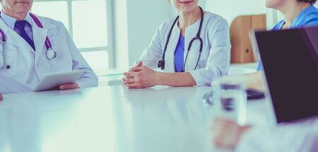 Serious medical team discussing patients case in a bright officeの写真素材