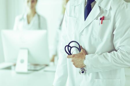 Young male doctor in front of medical groupの写真素材