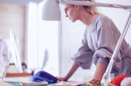 Fashion designer woman working on her designs in the studioの写真素材