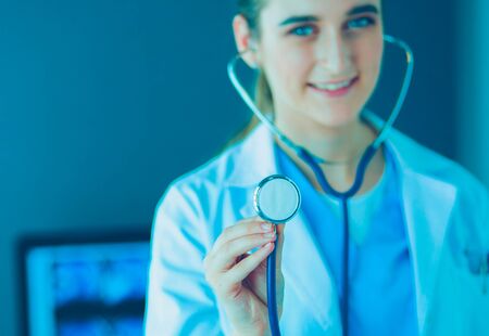 Close-up shot of doctors hands holding stethoscope at clinic.の写真素材