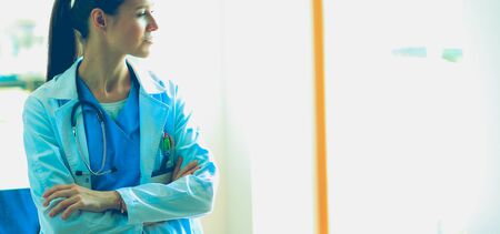 Woman doctor standing near window at hospital. Woman doctorの写真素材