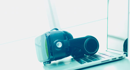 Virtual reality goggles on desk with laptop. business. 3d technology
