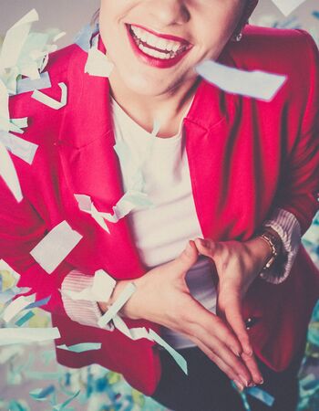 Portreit beautiful happy woman at celebration party with confetti .Birthday or New Year eve celebrating concept.の写真素材