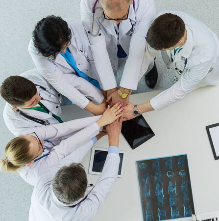 Medical team sitting and discussing at table, top viewの写真素材