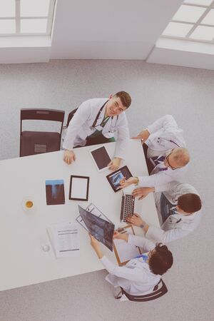 Medical team sitting and discussing at table, top viewの写真素材