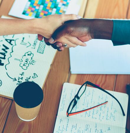 Business people handshake sitting on the desk in officeの写真素材