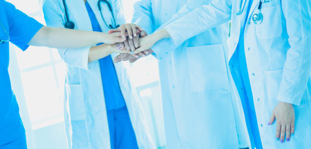 Group of doctors putting their hands together. Close-up