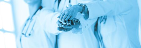 Doctors and nurses coordinate hands. Concept Teamwork in hospital for success work and trust in team.の写真素材