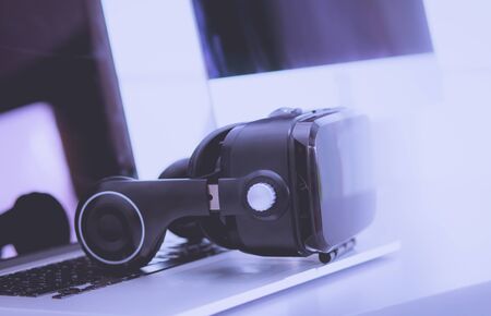 Virtual reality goggles on desk with laptop. business. 3d technologyの写真素材