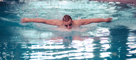 Male swimmer at the swimming pool. Underwater photo. Male swimmer.