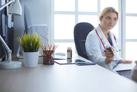 A doctor is talking and examining a patientの写真素材