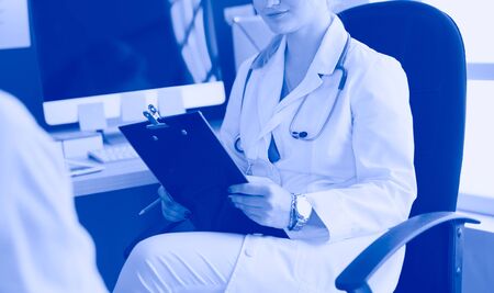 Woman doctor explaining diagnosis to her female patientの写真素材