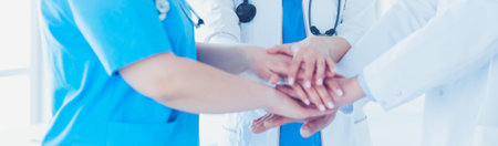 Group of doctors putting their hands together