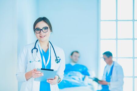 Female doctor using tablet computer in hospital lobbyの写真素材