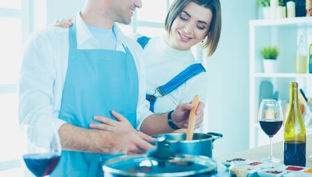 Couple cooking together in the kitchen at homeの写真素材