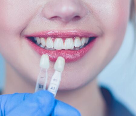 Dentist and patient sitting in dentist officeの写真素材